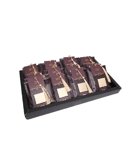 Tray with multiple small brown bags, each adorned with golden ribbons and labels.