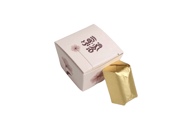 Decorative box with floral design containing a gold foil-wrapped item partially visible at the opening.